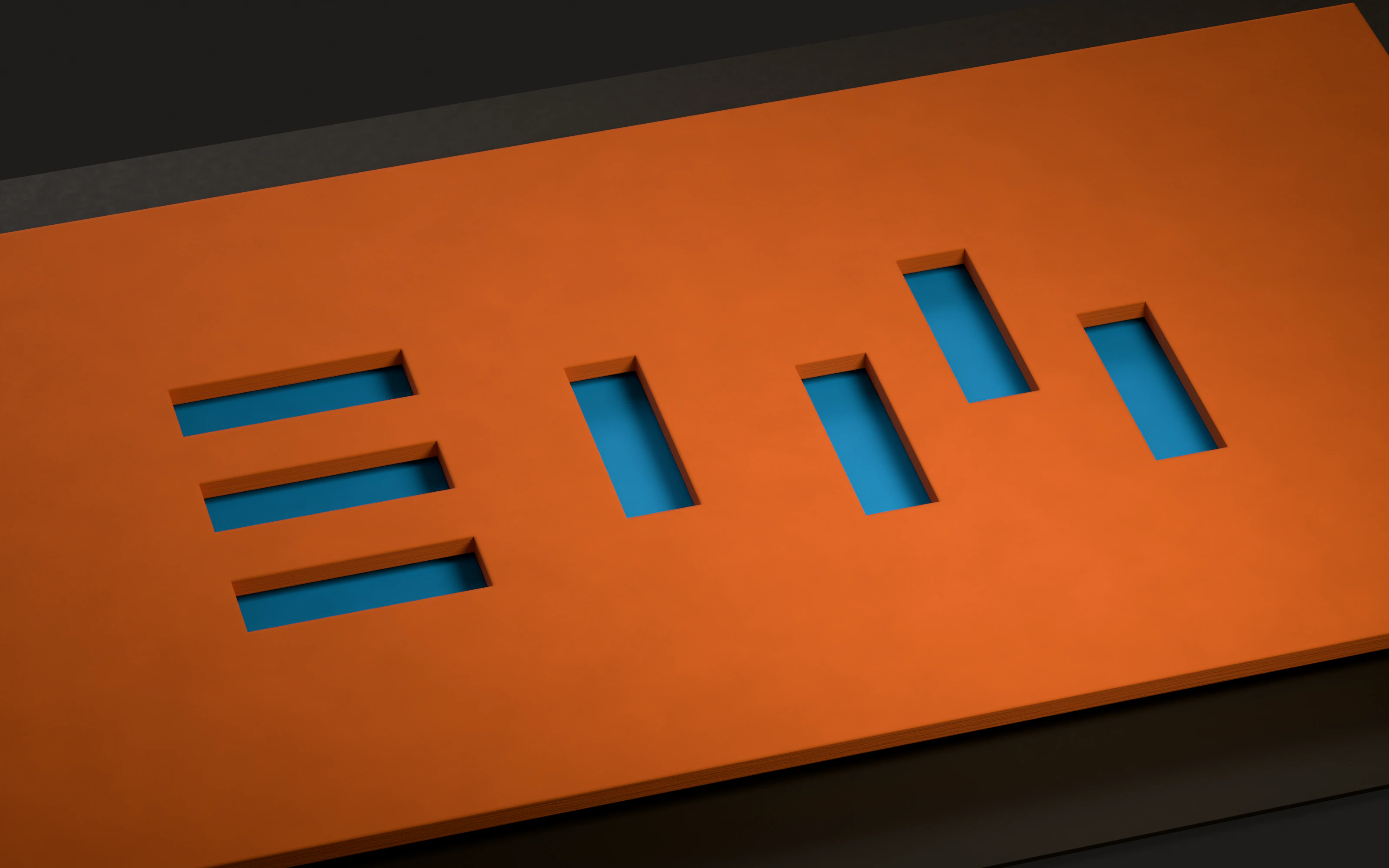 The EIM logo cut through a sheet of orange board, with blue board showing through the slots.